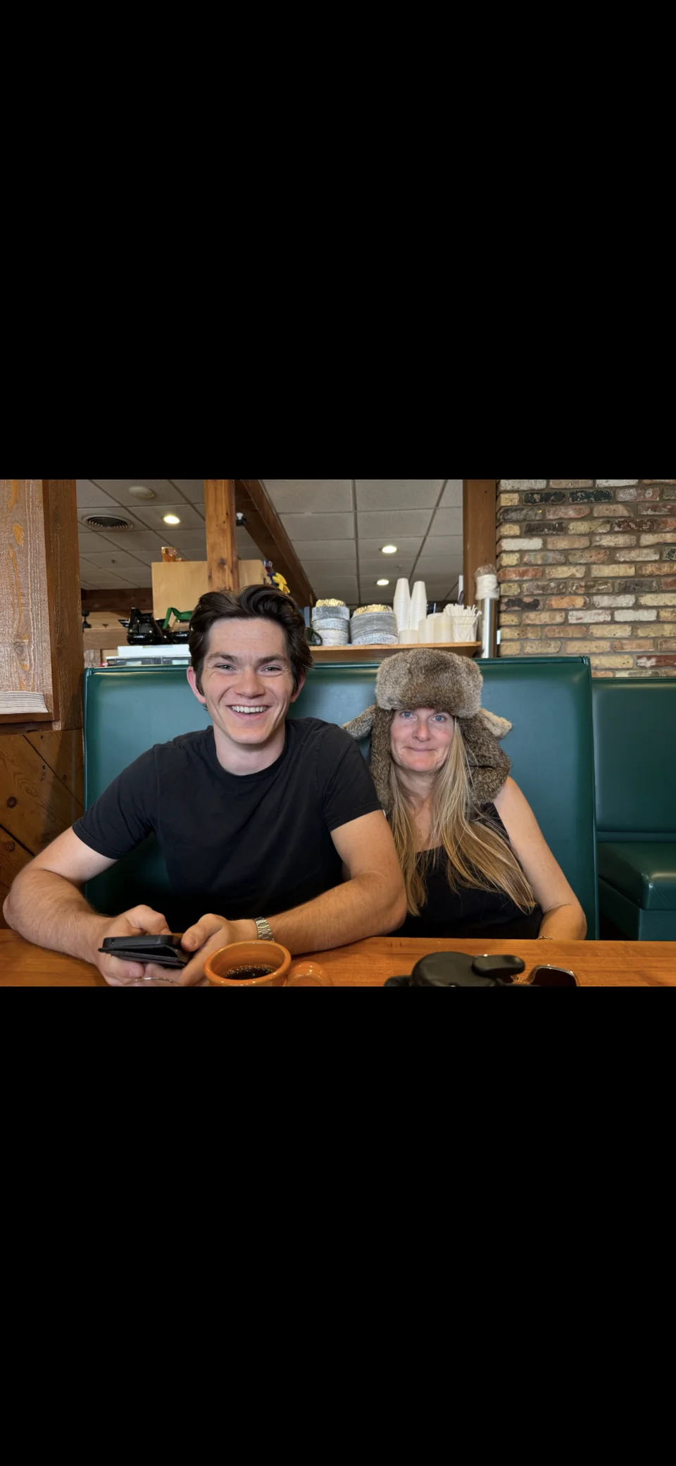 Two people sitting together at a restaurant table.